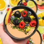 Colorful bowl of fresh fruits with a mix of berries and seeds, perfect for a healthy meal.